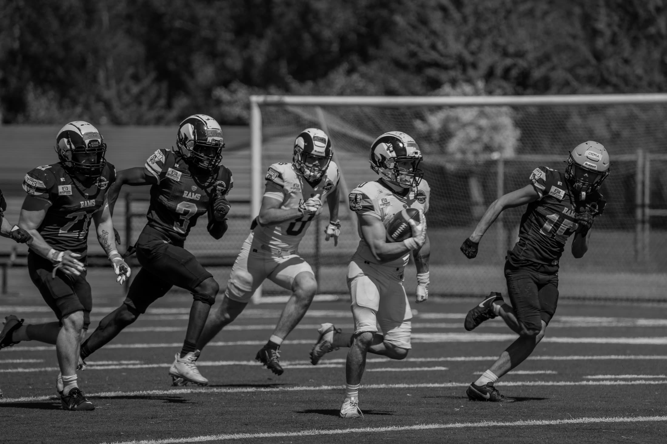 Caiden breaking away with the ball on the field